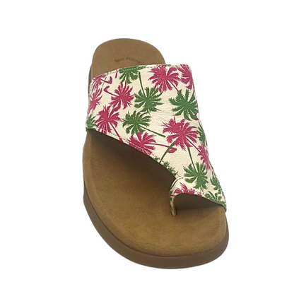 Slip on sandal in a cream with pink and green palm trees depicted.  Toe loop with full coverage to top of foot but angled on outside.  Slip on style with no backstrap