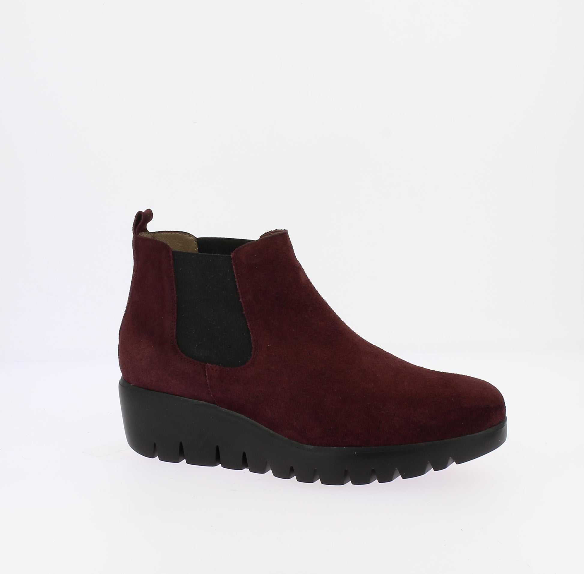 Dark wine coloured suede boot with a thick platform, wedge  sole and black elastic side cut out is pictured in profile.