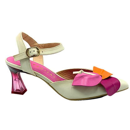 Outer view of dress sandal in a cream color with softly pointed toe and leather flower detail on front.   Heel is a fuschia lucite.