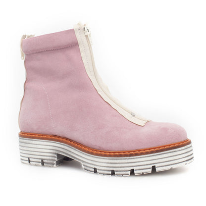 A pink suede boot with front zipper and white rubber, lugged sole pictured in right profile. 