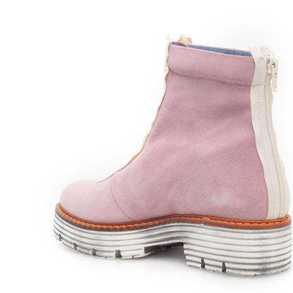 Rear view of a pink suede short boot. The boot has a white zipper up the back of the boot and white lugged sole.