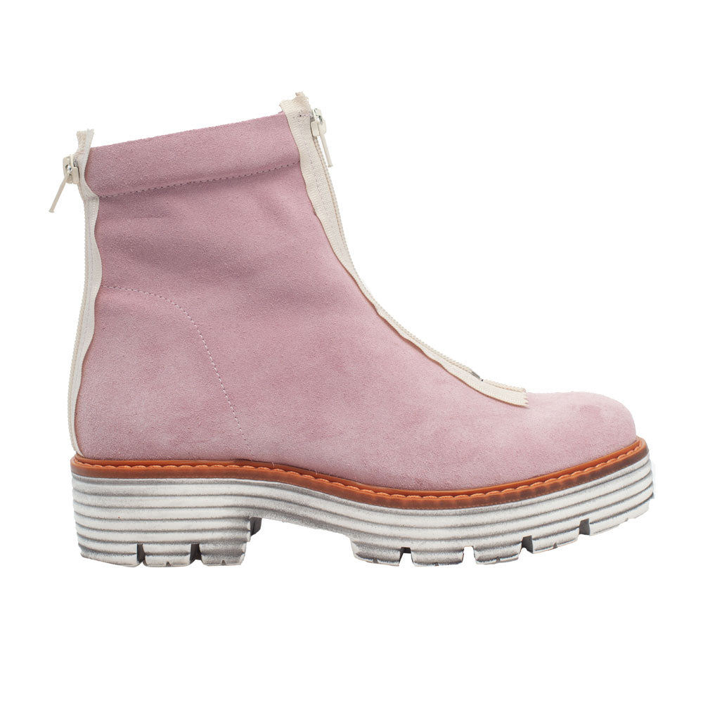 A pink suede boot with front zipper and white rubber, lugged sole pictured in right profile.