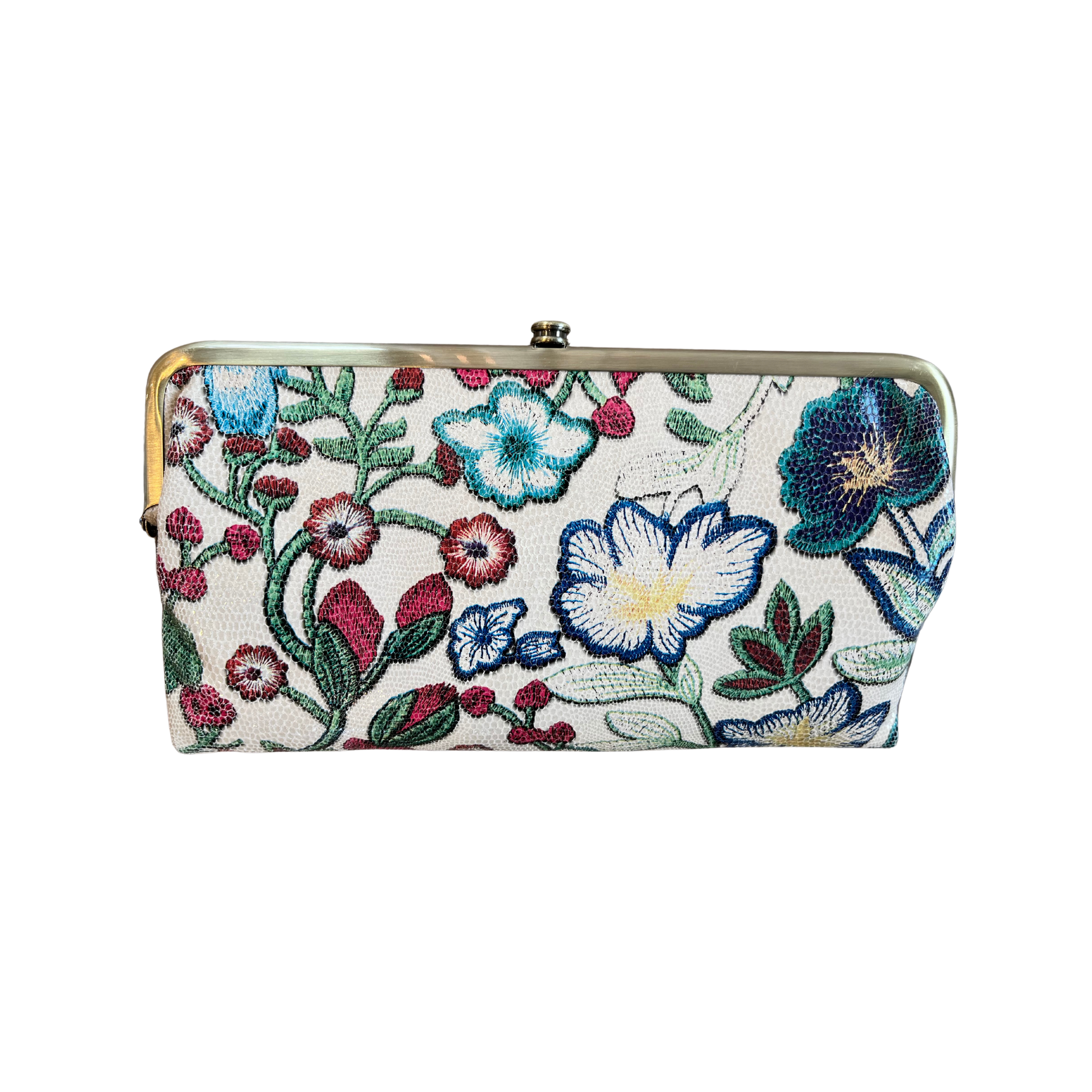 A wallet is shown in a floral stitch colour way. The flower colours are blues, reds, greens and yellow. The hardware is brushed antique brass.