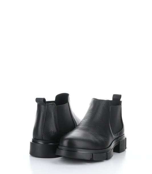 A pair of short black ankle boots is shown. The boots have black elastic side panels and a lug soles. 