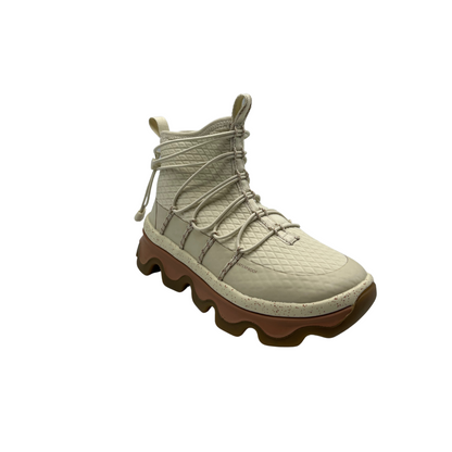 One plush wave boot shown in profile in the colour white. The boot has an egg carton inspired sole. Toggle lacing system across the front of the boot for easy on and off. 