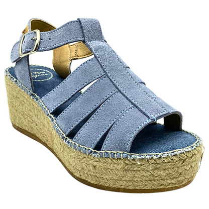 Angled side view of a chunky wedge espadrille.  Upper is a soft blue leather.  Open toe and heel with a buckle adjustment at ankle cross strap