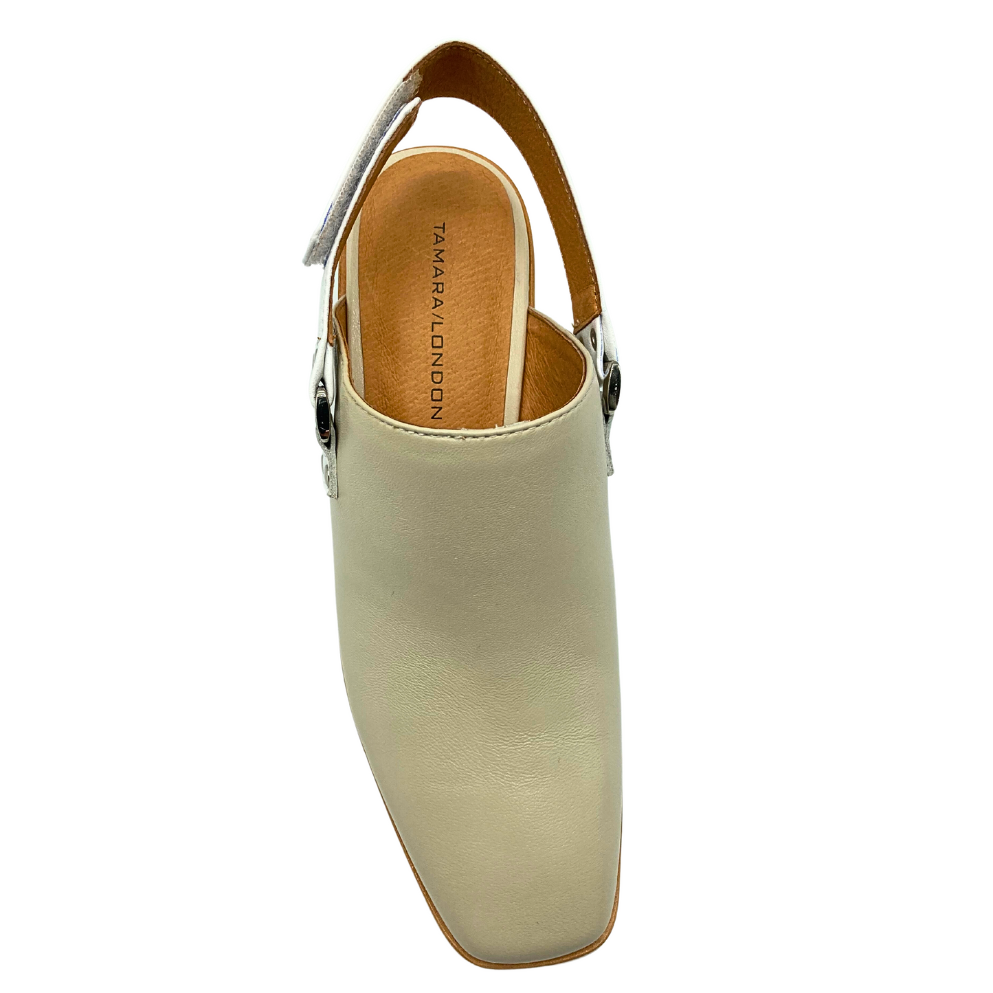 Top down view of a closed toe shoe with an open back.  Taupe color leather upper and a white back strap