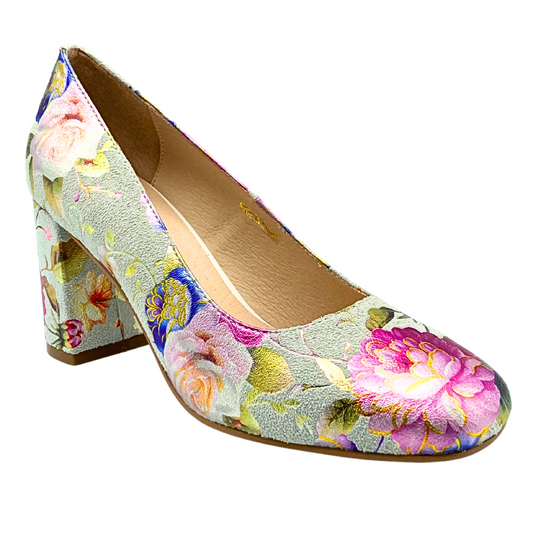 Angled front view of a dressy pump with a medium black heel.  Shown in a gorgeous cream base with soft floral details.