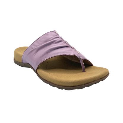 Angled side view of the Taos Gift 2 sandal in Lavender.  Toe post slip-on sandal with no back strap
