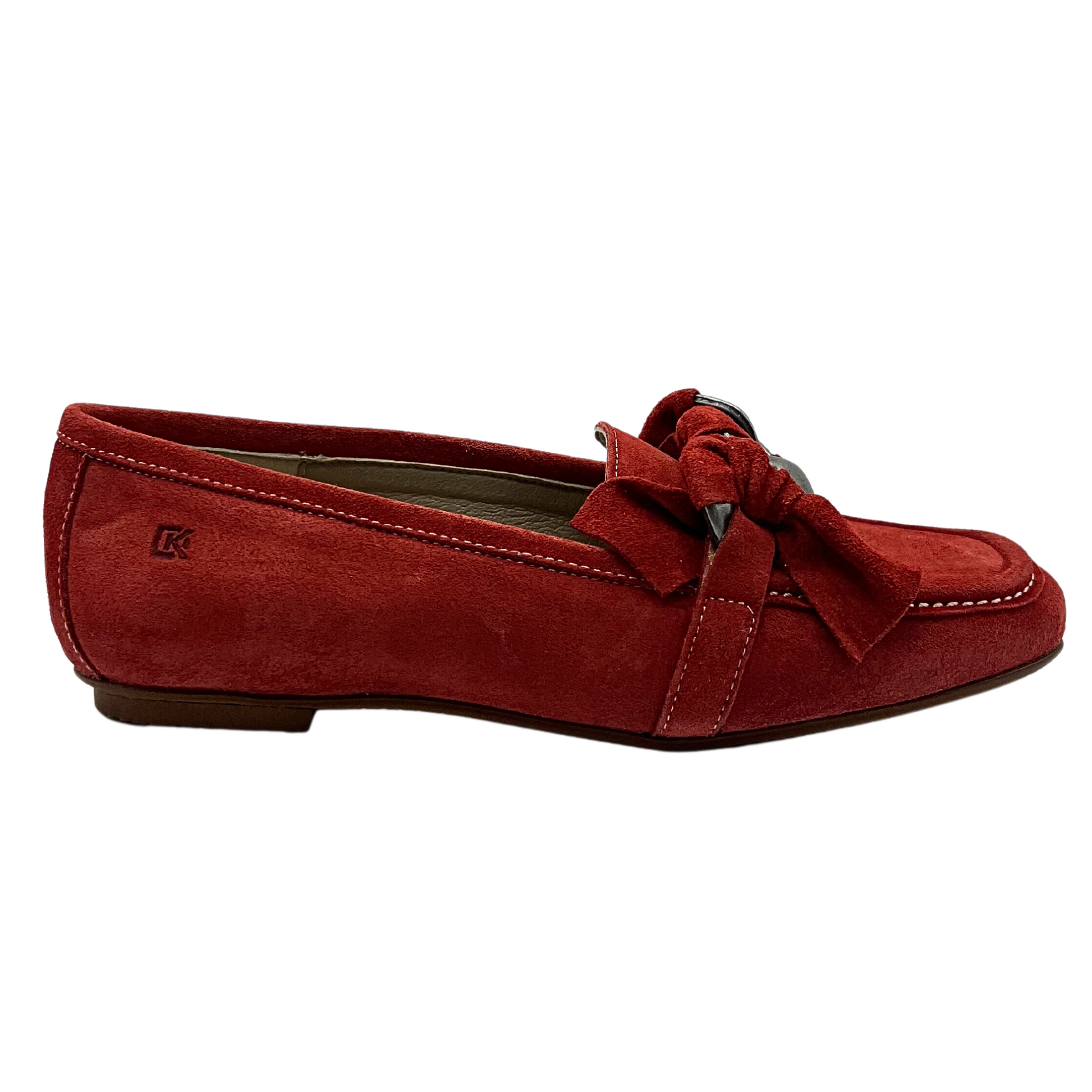 Outside view of a slip on moccasin style loafer.  Over the top of foot is a knotted leather/metal chain detail