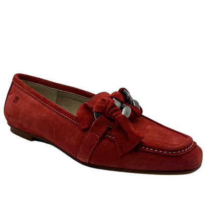 Angled side view of a moccasin style loafer done in terracotta color with contrasting white stitching.