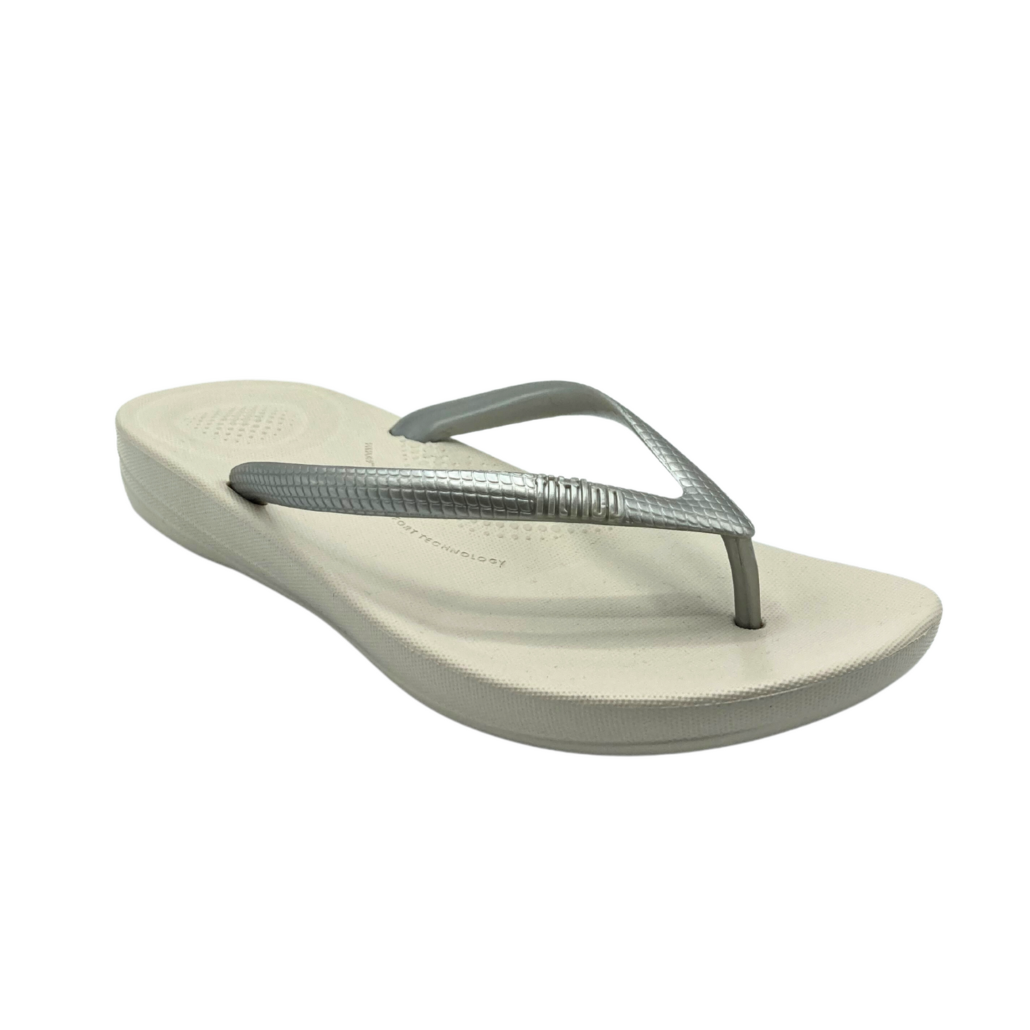 Angled side view of a cushioned flip flop with great supportive footbed.  Shown in silver (straps are silver and footbed is more light taupe)