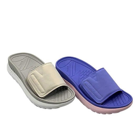 Angled front view of a great beach slide with arch support.  Shown in 2 colors - taupe/grey and deep lilac.
