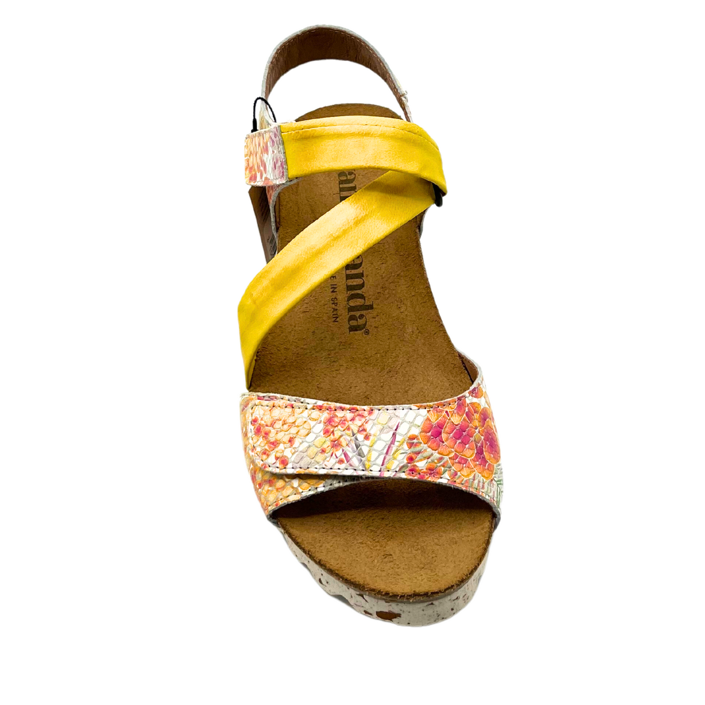 Top down view of a summer sandal in a fun yellow and floral pattern.
