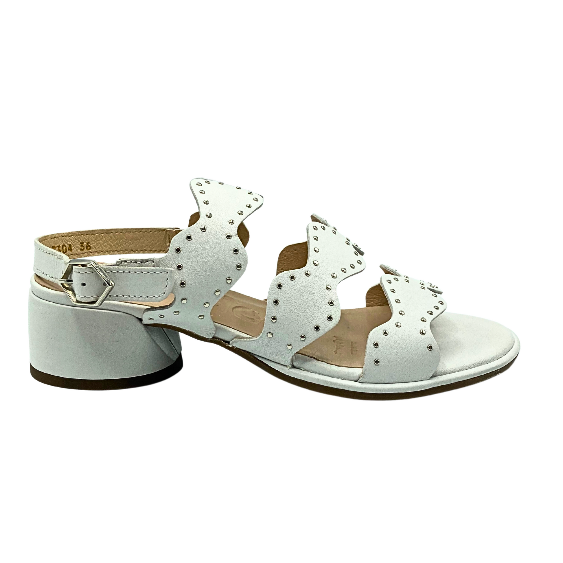 Outside view of a white leather sandal with scalloped straps.  Heel strap has buckle.  Round leather wrapped heel