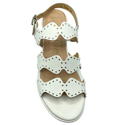 Top down view of a white leather sandal wth tiny silver stud details on the straps.  Three straps across the foot with scalloped details.  Open toe and heel with adjustable heel strap