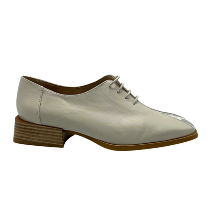 Outside view of a taupe tailored shoe.  Slight, square heel is a stacked wood.  Upper is leather