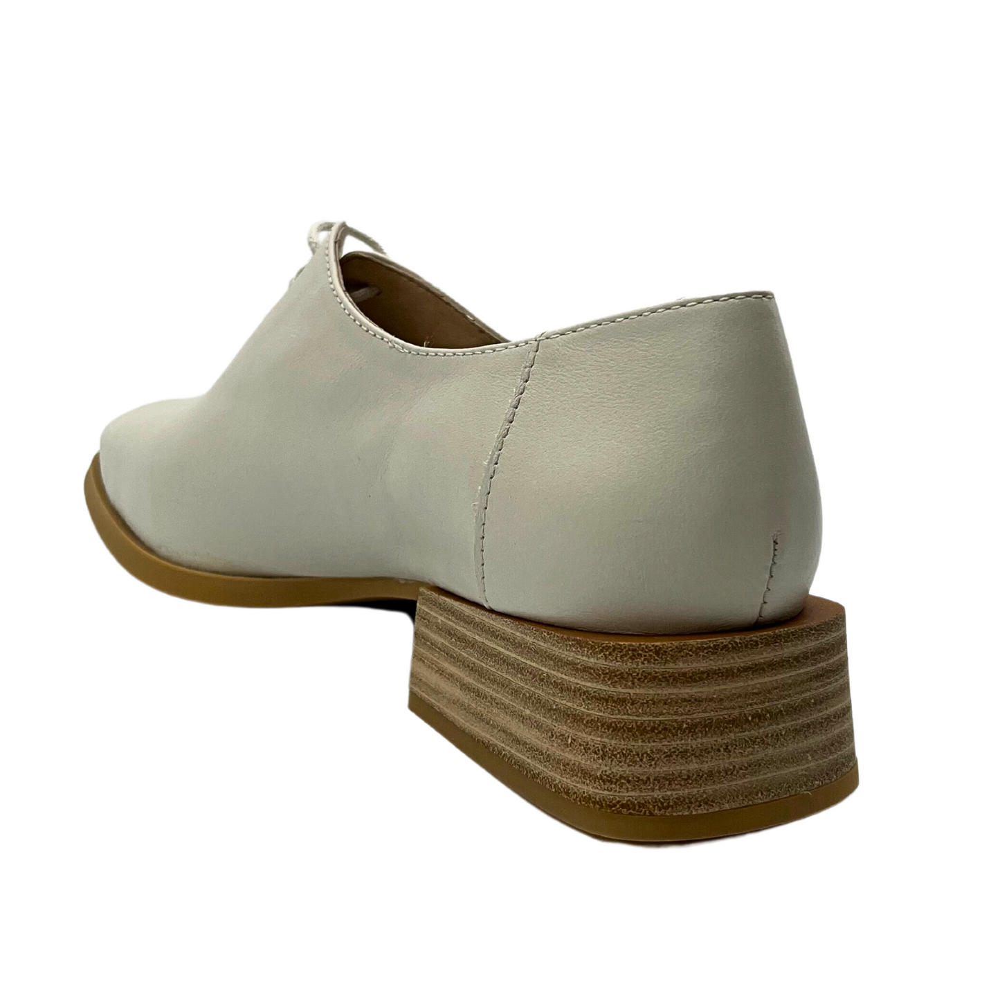 Angled rear view of a tailored tie up loafer with a square block heel.  Heel is low and done in a stacked wood