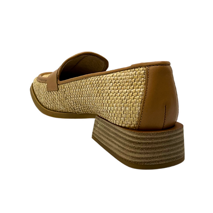 Angled rear view of slip on loafer.  Textured leather looks lke raffia.  Trim and heel wrap are a smooth tan leather.