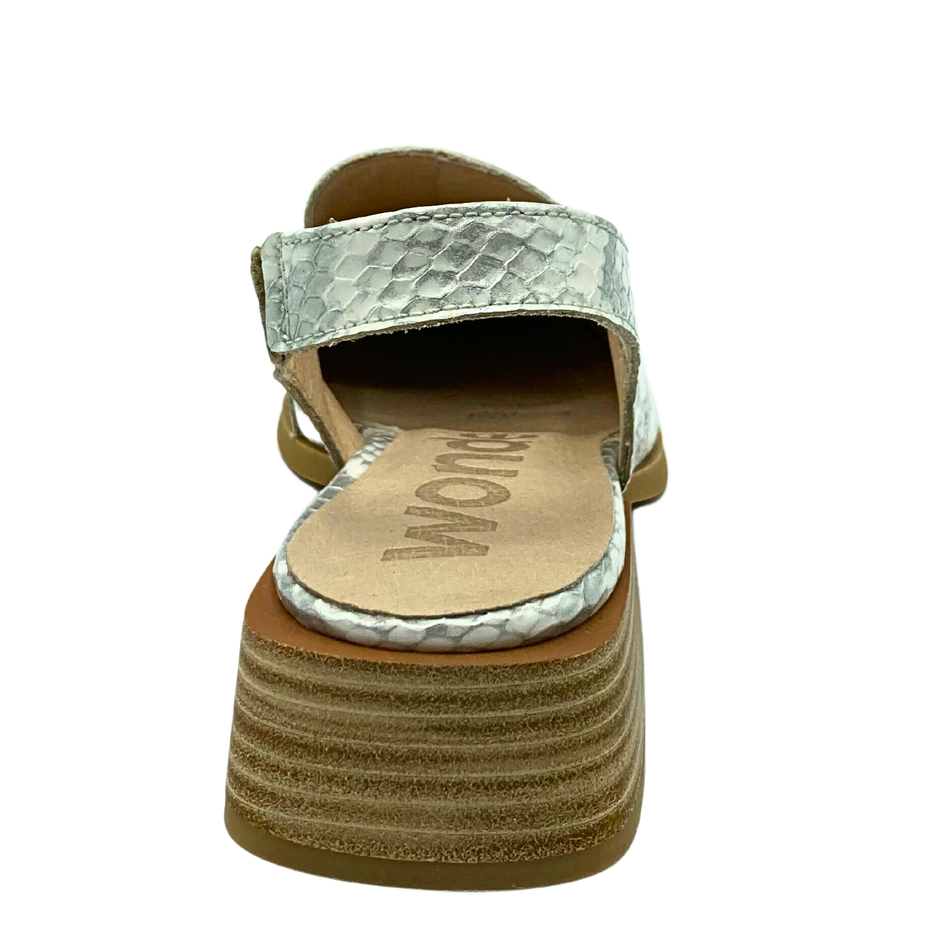 Rear view of slingback shoe with closed toe.  Low, stacked wood heel