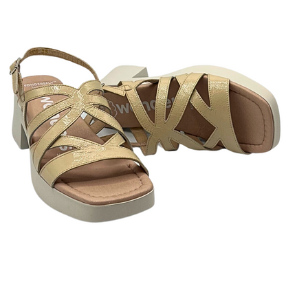 Angled front view of a pair of sandals in a neutral taupe 