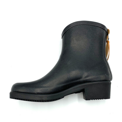 Ankle height black boot pictured in profile showing the opposite side. block heel and leather ribbon are visible.