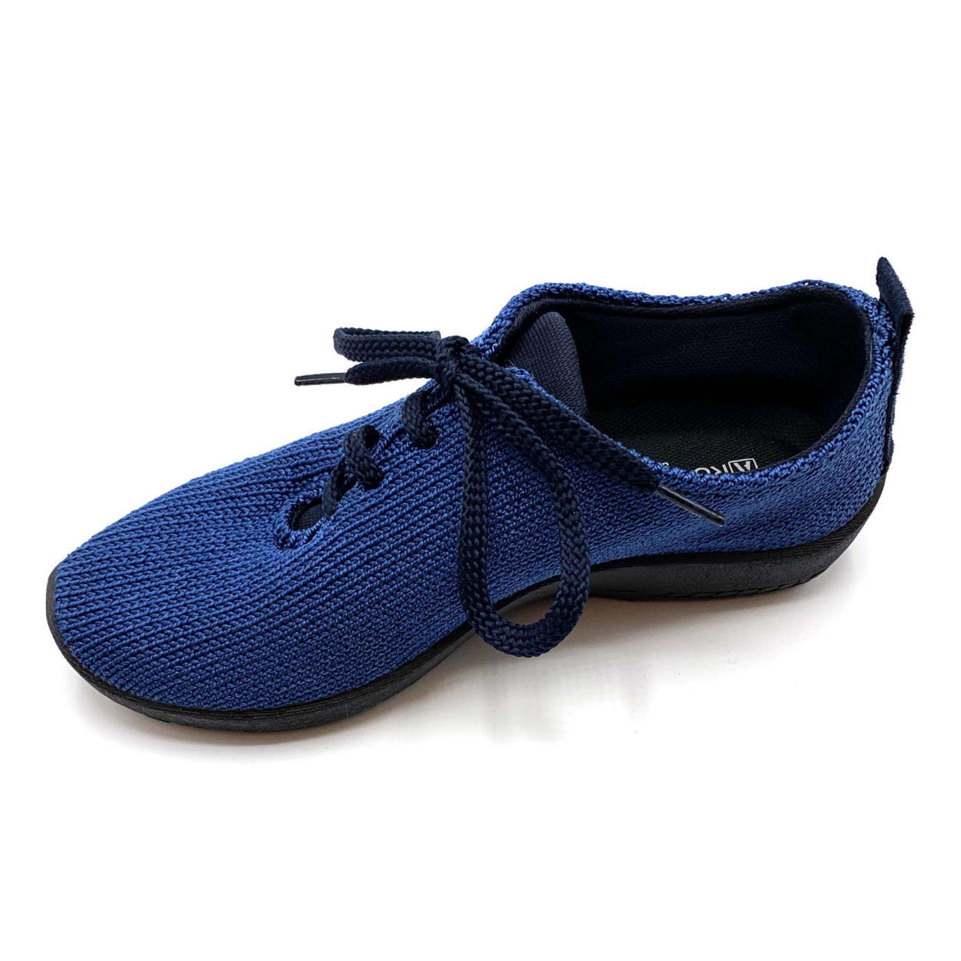 Angled view of knit blue sneaker with black sole/lining and shoe strings.