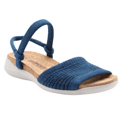 A blue knitted sandal with toe, ankle, and heel bands is attached to a cork and white perforated sole.