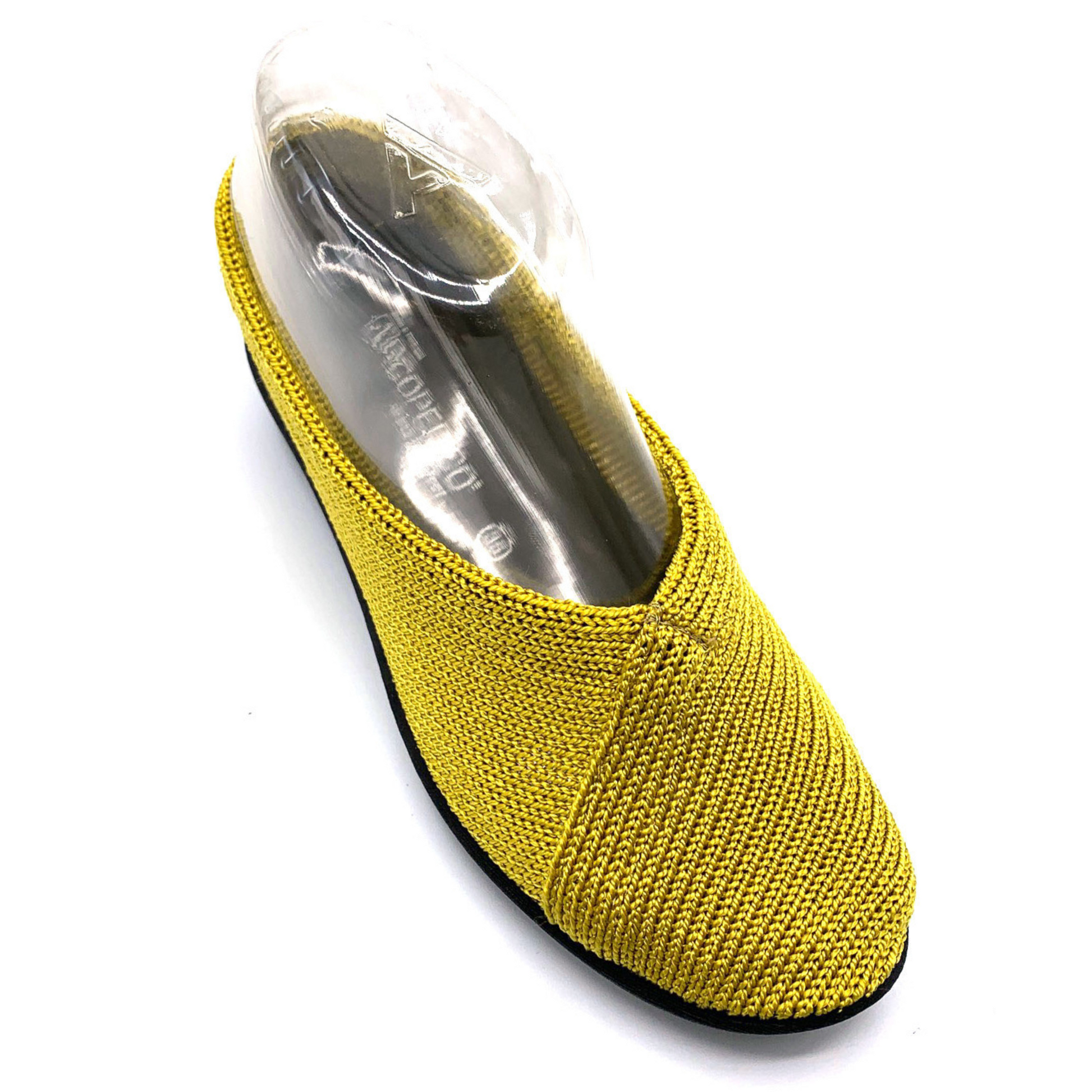 A yellow knit sneaker is pictured at an angle with the top-line crossing diagonally across the front side.