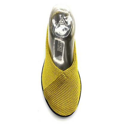 A yellow knit shoe is pictured from the top showing the direction of knit with a crossed over texture that extends from the centre top line down across the side.