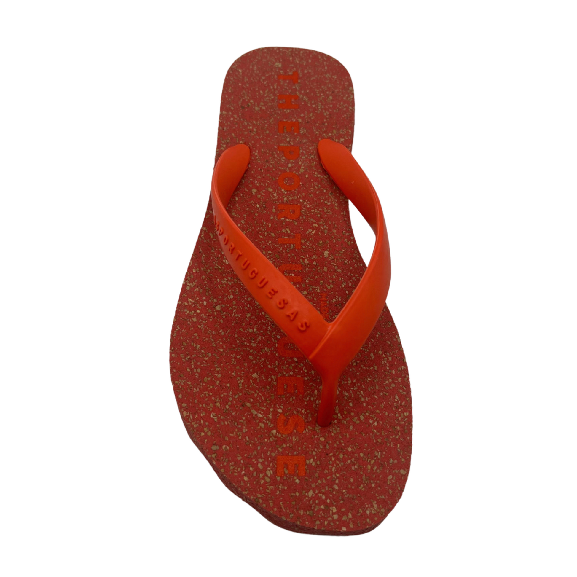 A red speckled flip-flop is pictured with red Y shaped strap from the front.