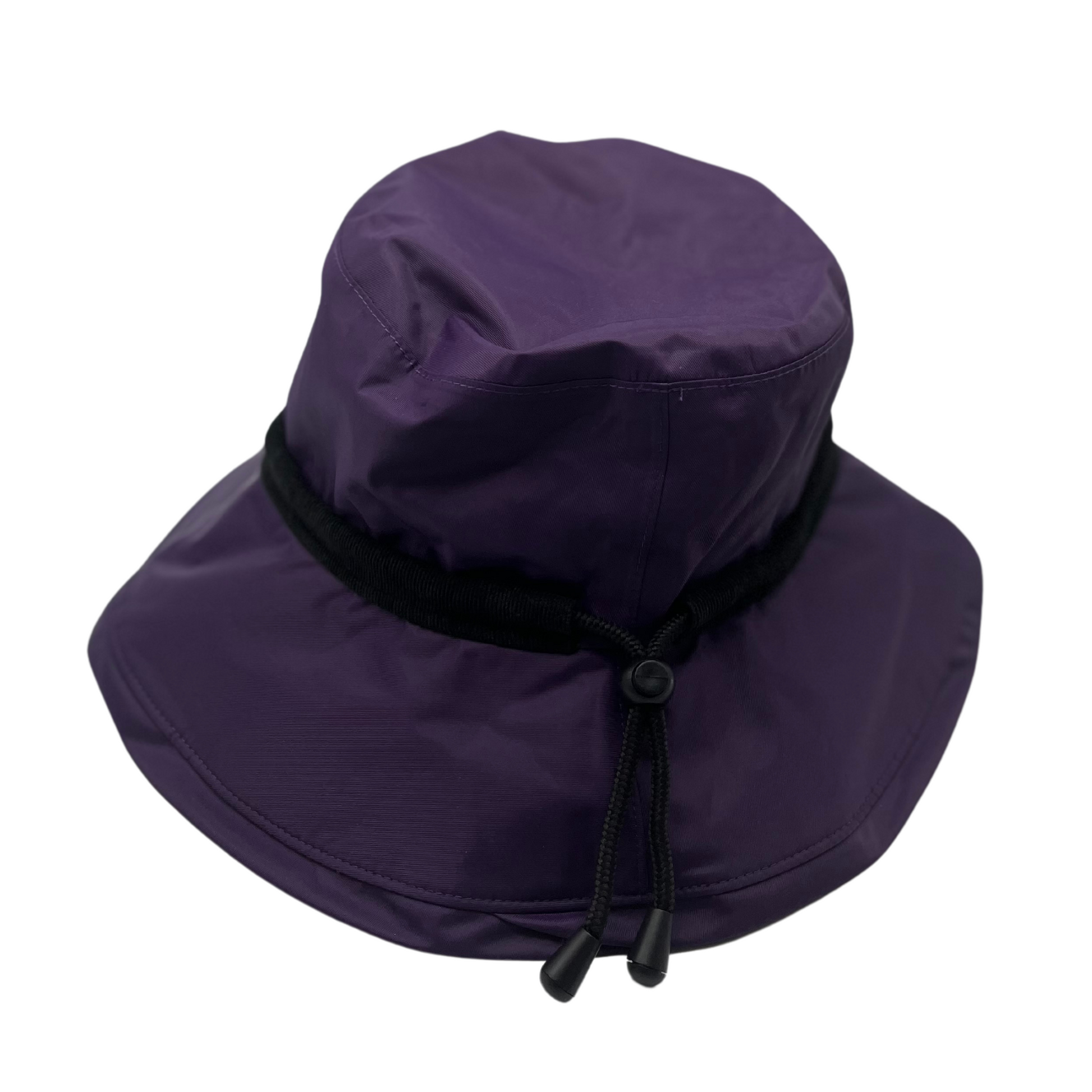 A front view of a purple hat with a black drawstring.