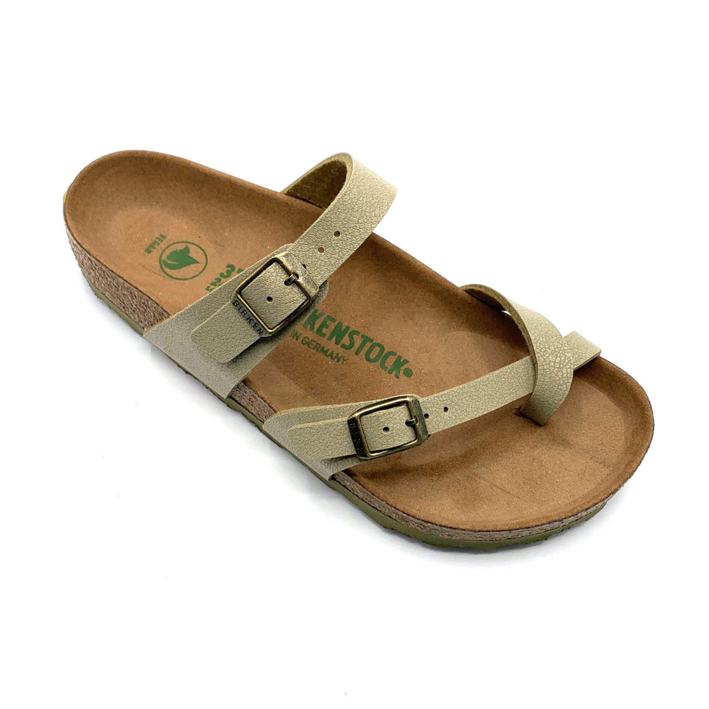 A 45 degree angle view of a sandal with a caramel-brown cork sole, two light-khaki straps, and brushed nickel buckles. One of the straps goes over the upper part of the foot, and the other goes between the toes.