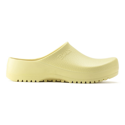 A right side view of a pale yellow clog with a grippy bottom.