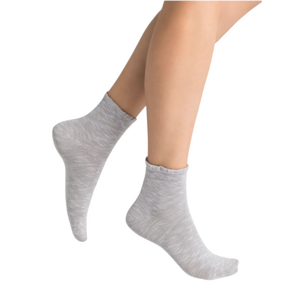 A pair of light grey ankle height socks is pictured featuring a frilled top.