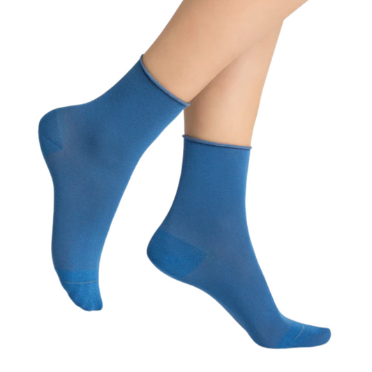 A plain blue sock with rolled cuff is pictured posed  in profile.