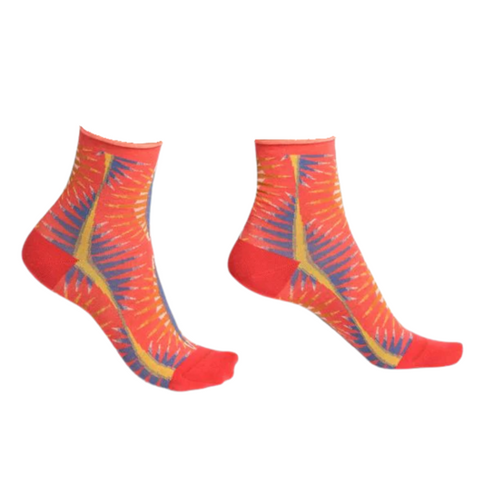 Fiery red, yellow, and blue patterned socks are pictured in profile.