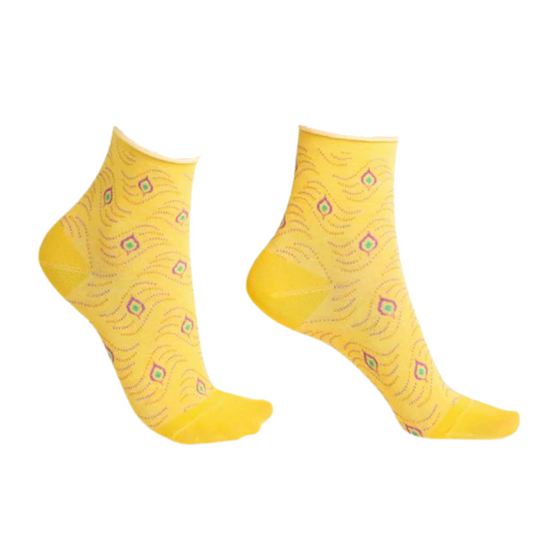 A yellow pair of socks with wave and pendant pattern is pictured in profile.