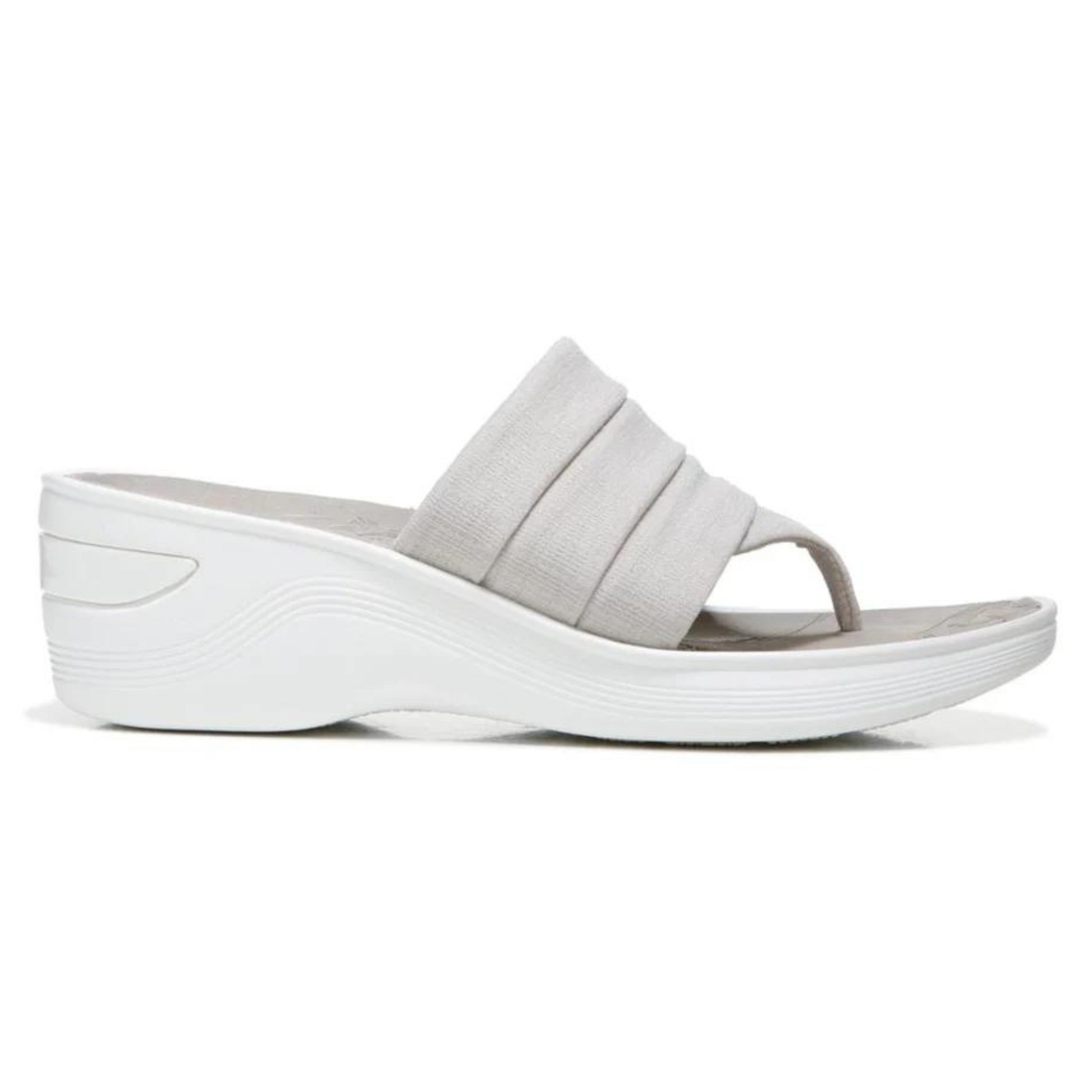 A grey sandal is pictured in profile with pleated upper strap and thong toe holder. The footbed is grey while the white wedge outsole is white.