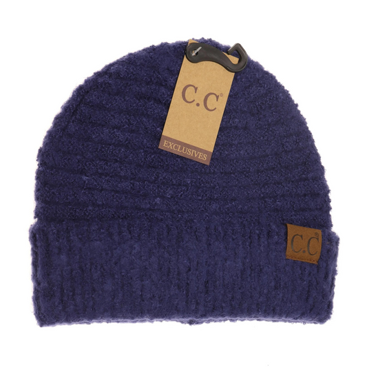 A front view of a dark blue knit beanie.