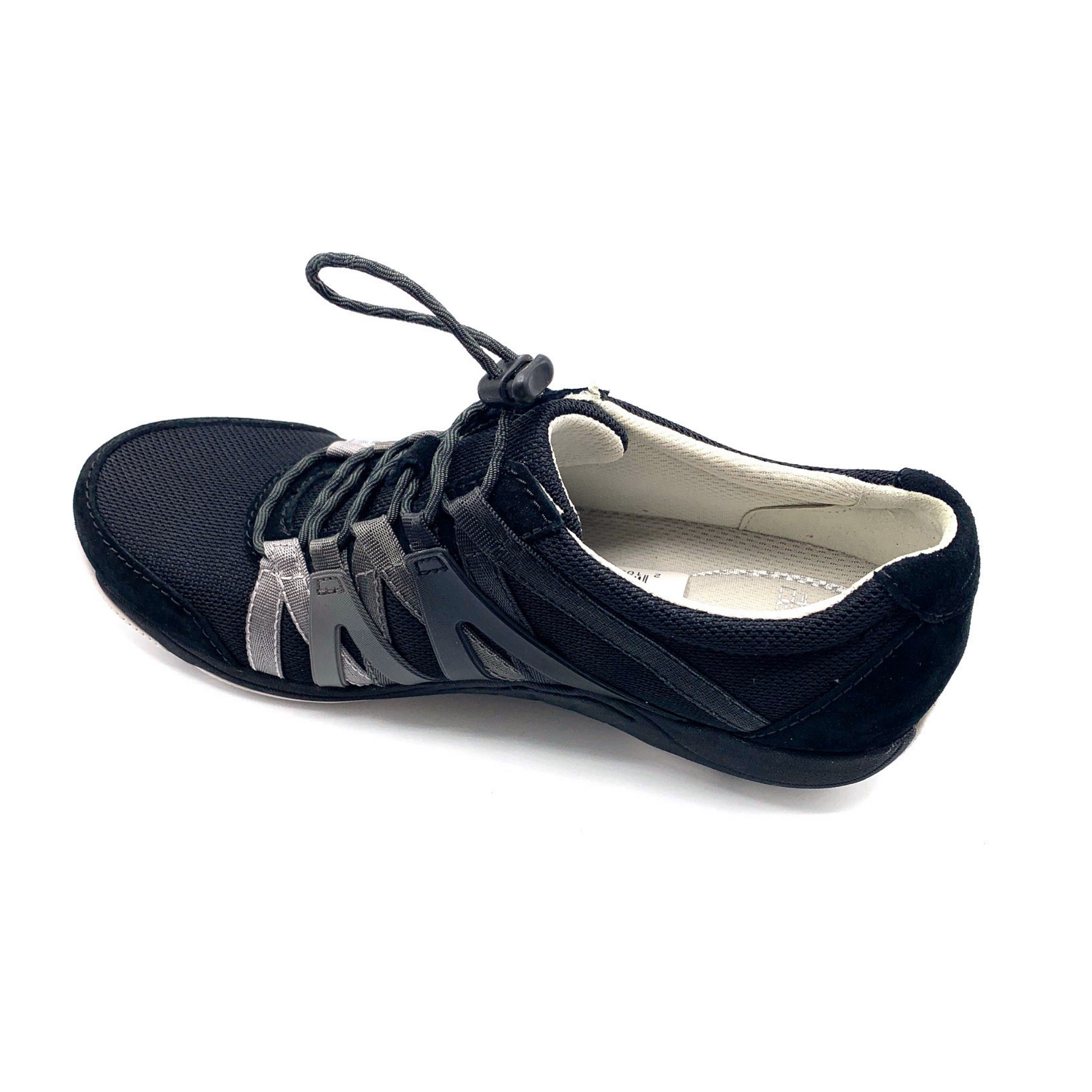 A black sneaker viewed from a left-top angle. The shoe has black cord-like laces, a mesh top, suede detailing, and an Ombre zig-zagged side pattern.