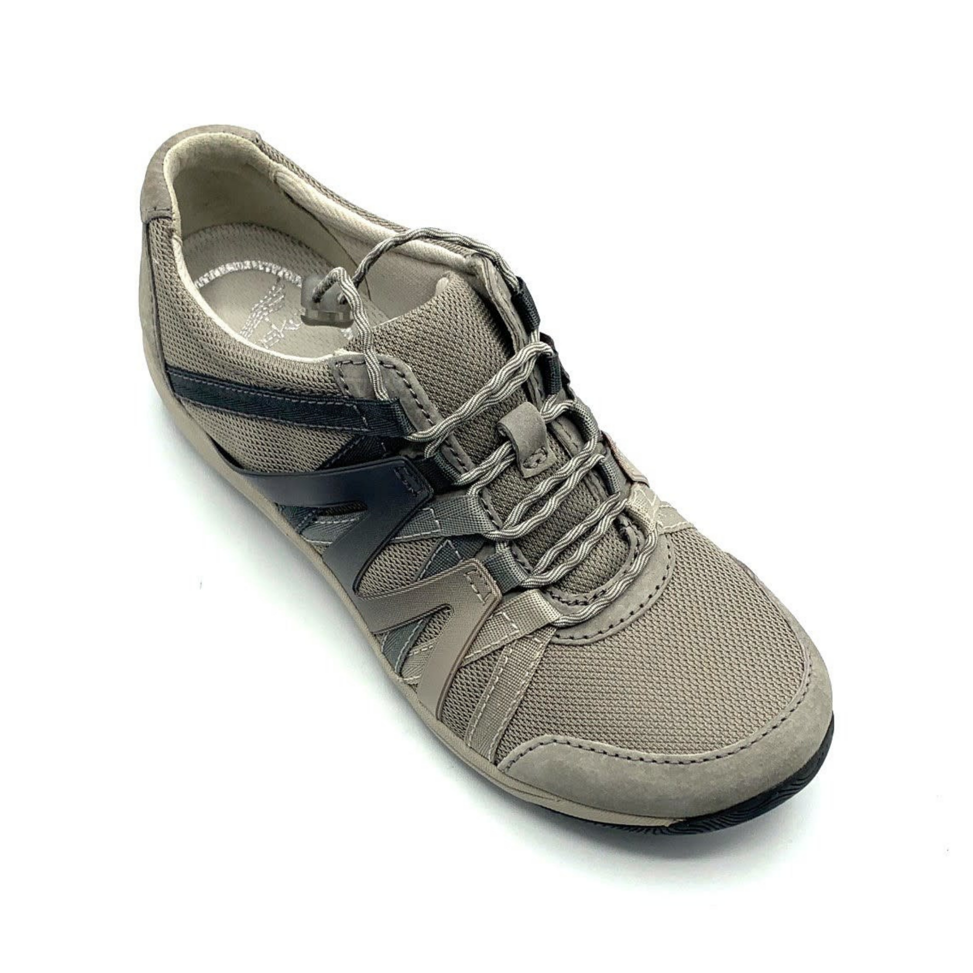 A warm grey sneaker viewed from a 45 degree angle. The shoe has grey cord-like laces, a mesh top, suede detailing, and an Ombre zig-zagged side pattern.