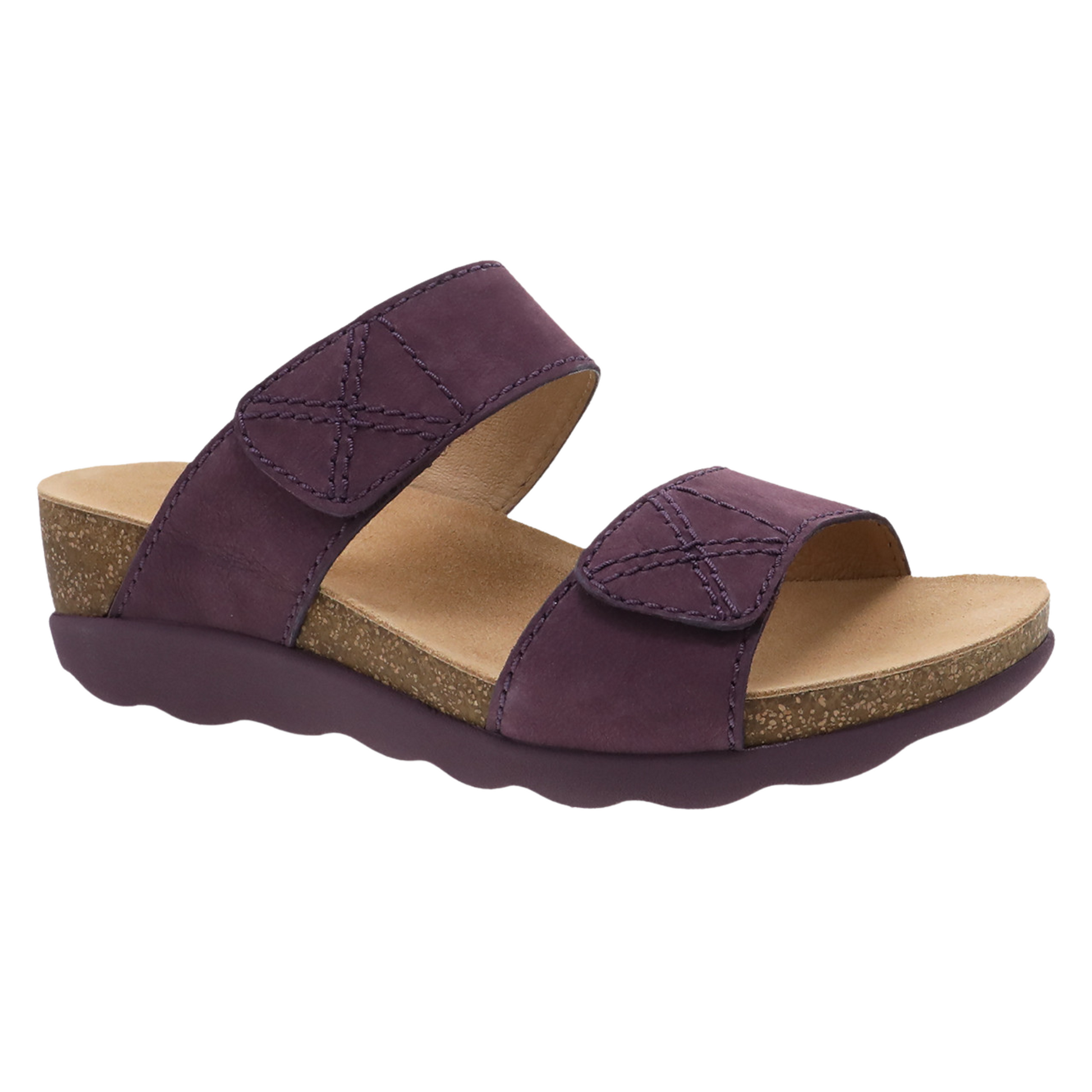 A purple sandal with two leather bands is pictured at an angle and features a purple outsole and cork wedge midsole.