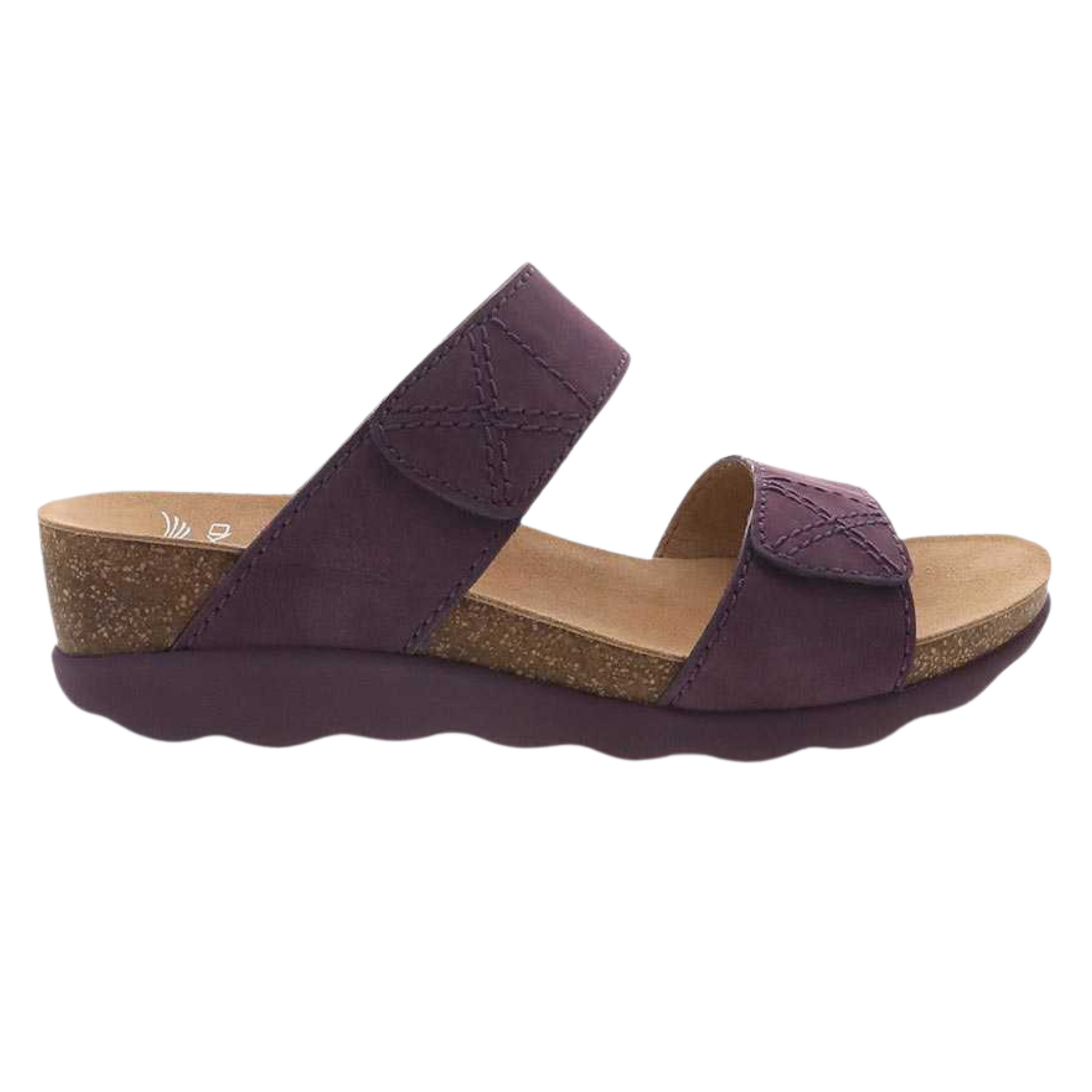 A purple sandal is pictured in profile with a curvy outsole, two leather straps, and cork midsole.