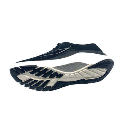 A left side view of a black mesh sneaker with a white and black grippy outsole.