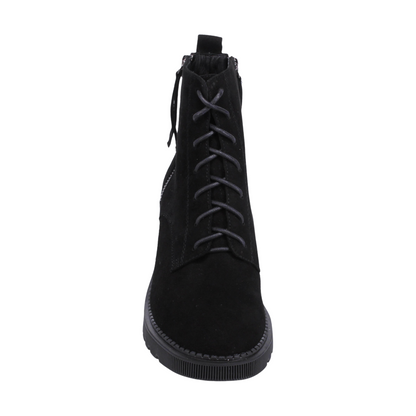 A front view of a black suede, heeled boot with side zippers.