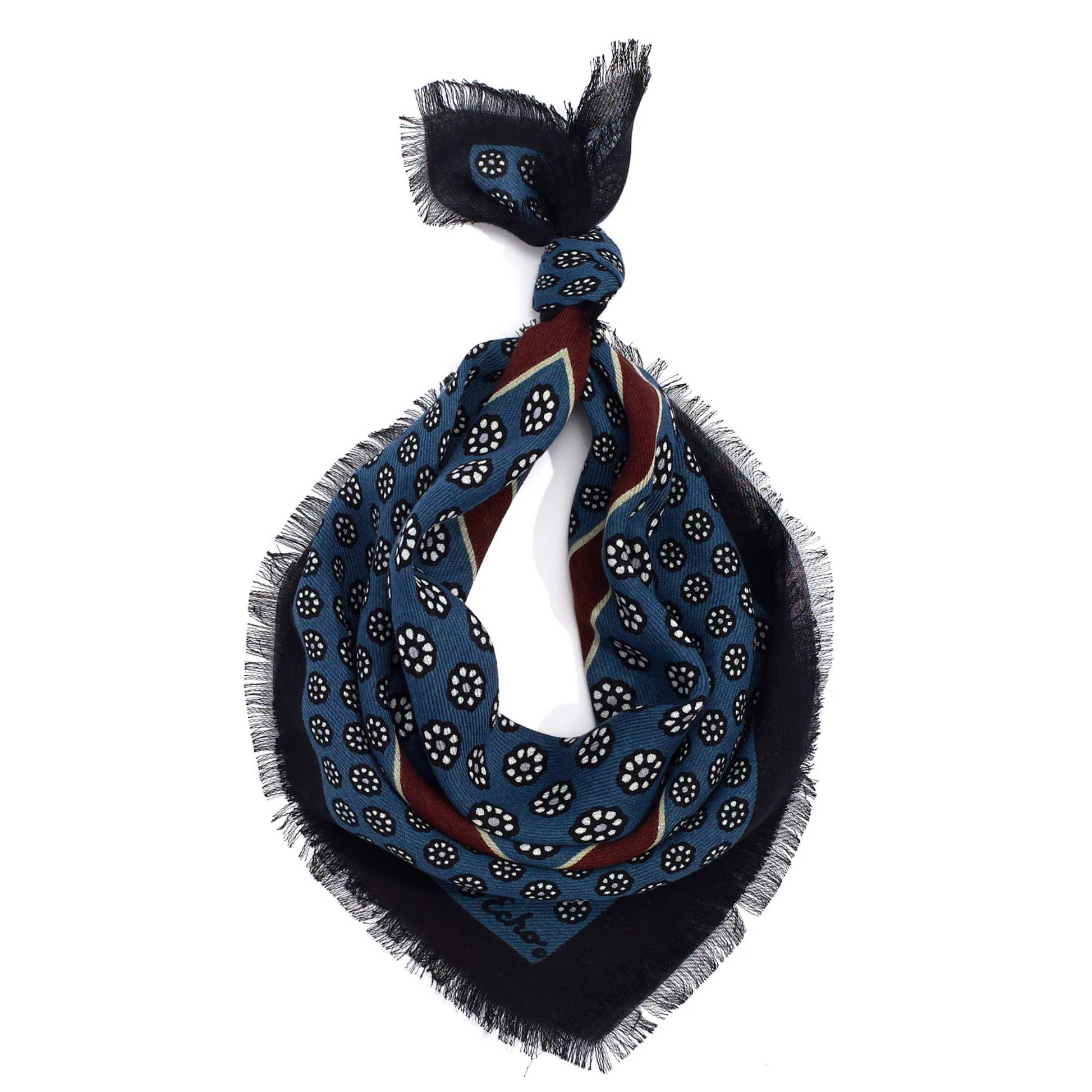 A blue floral and navy frayed scarf tied in a loop.