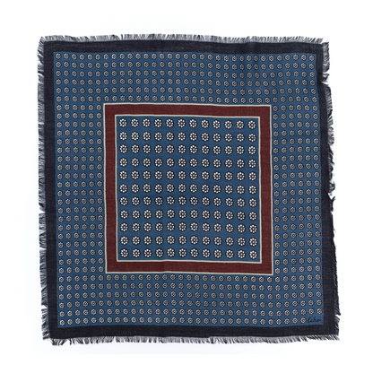 A grid floral printed scarf in a deep blue with frayed edges and maroon central square.