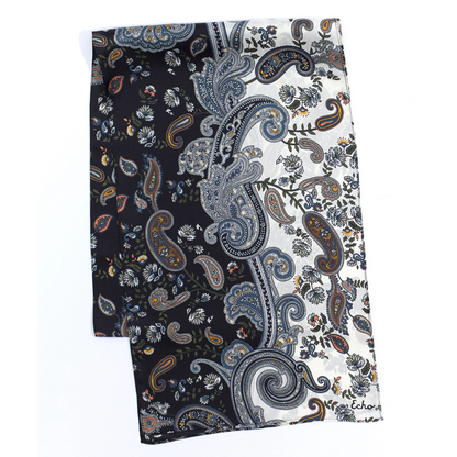A black and white paisley printed scarf is pictured folded, showing the ochre and navy detail.