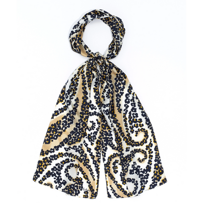 A white and tea stain coloured scarf with black spotted pattern in paisley shapes is tied in a loop.